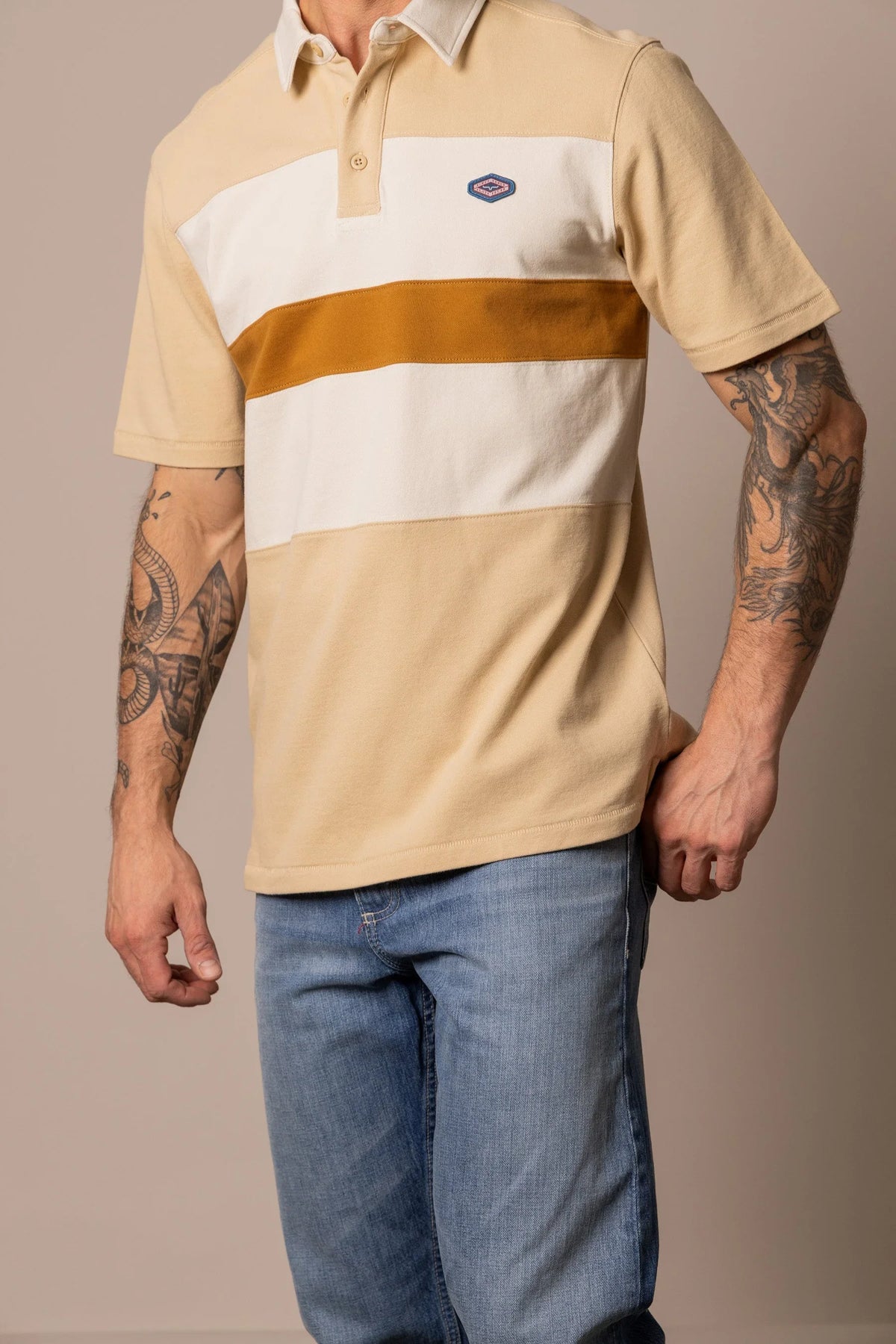 Kimes Ranch 1874 Polo in Tan with white and mustard horizontal stripes and a small logo on the chest