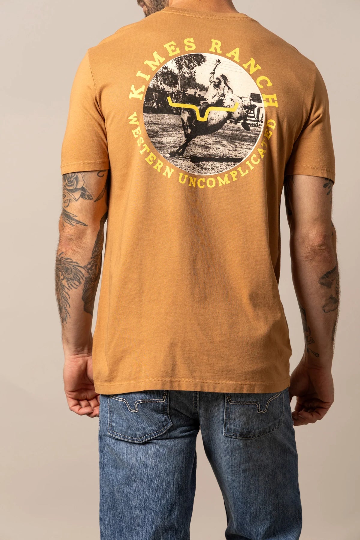 Kimes Ranch 1956 shirt in Work Wear Brown, back view, with a back graphic of a cowboy on a bucking horse