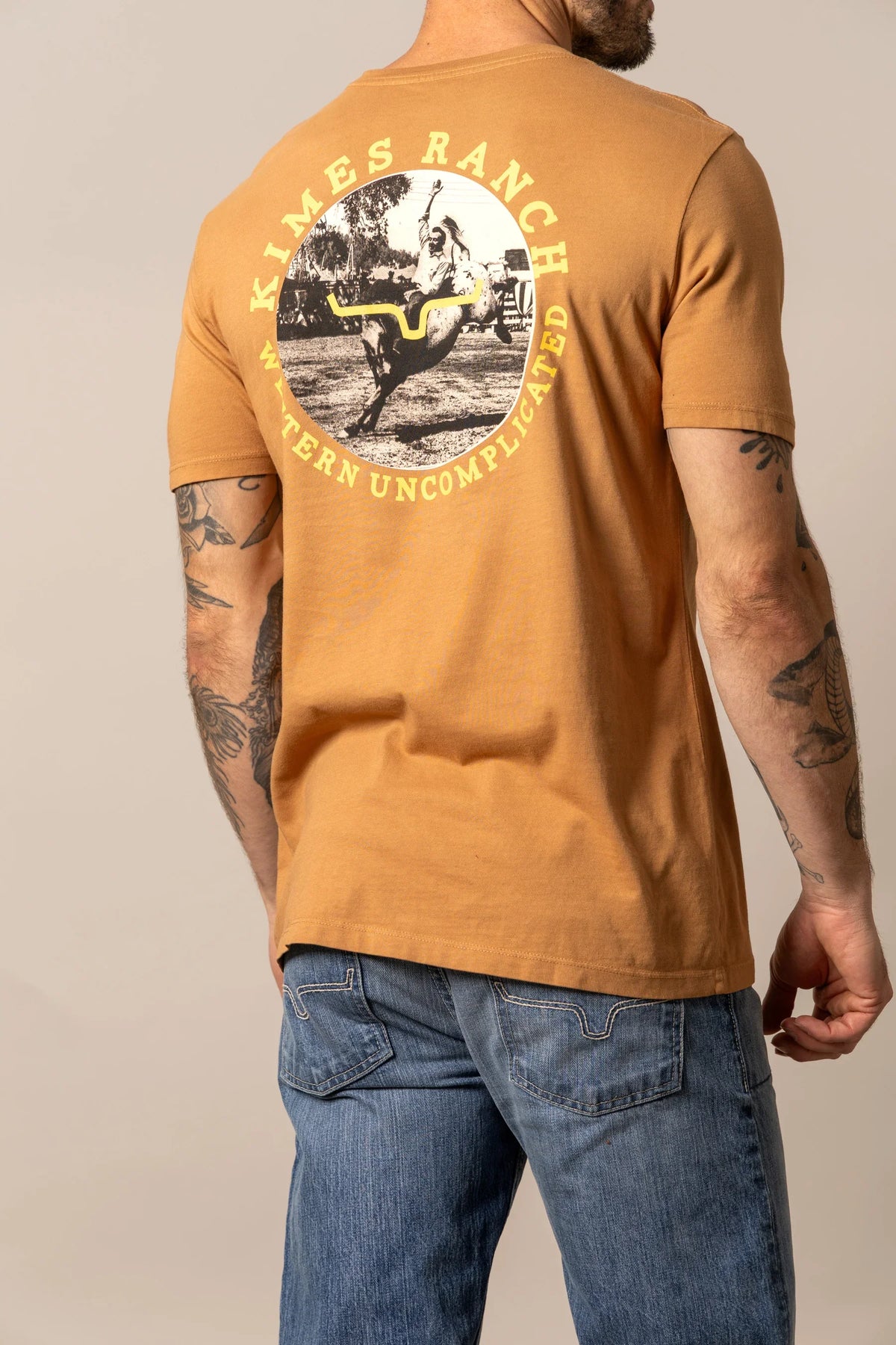 Kimes Ranch 1956 shirt in Work Wear Brown, back view, with a circular back graphic of a cowboy on a bucking horse