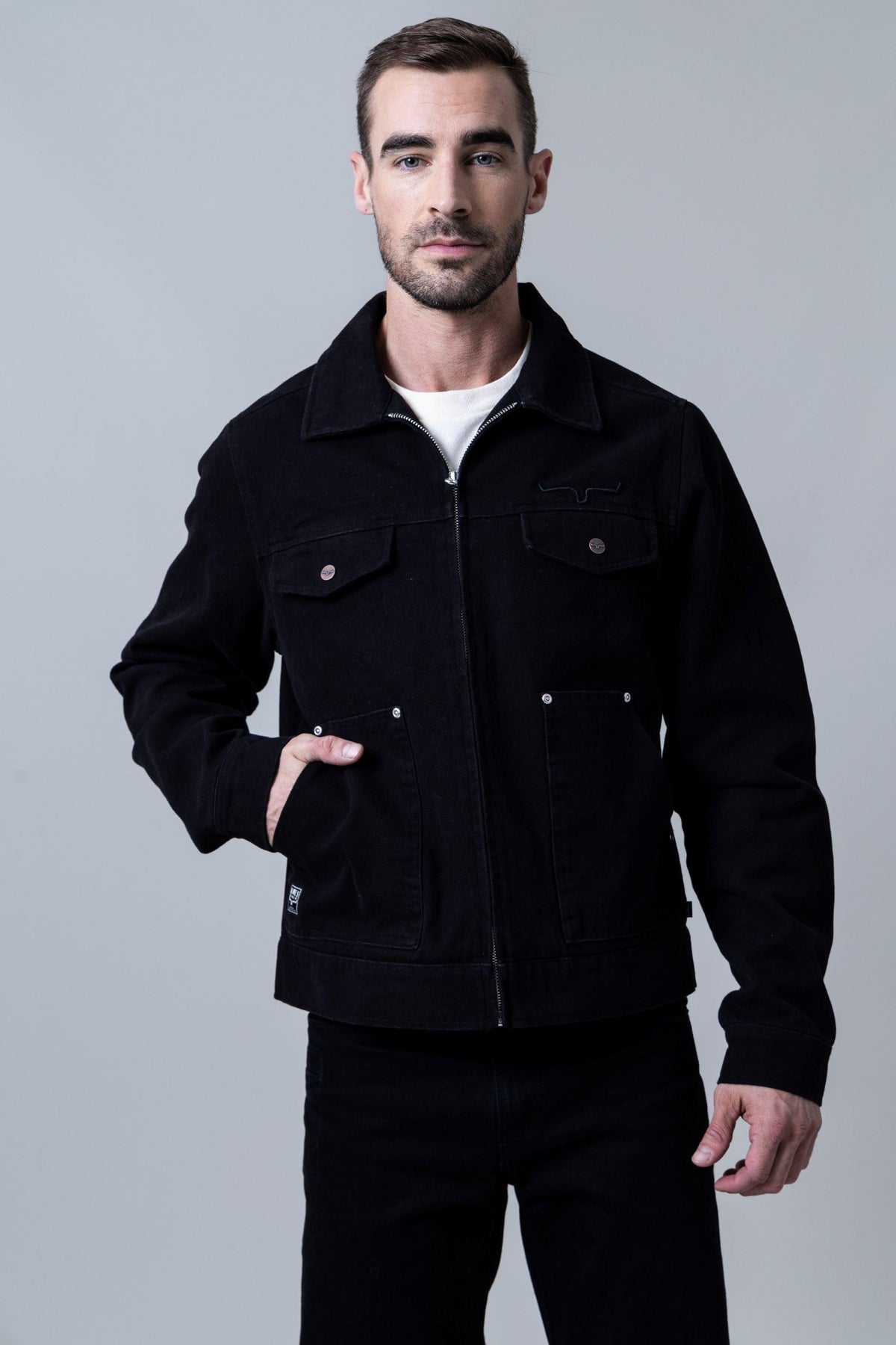 Kimes Ranch Logan Jacket in Black with a zip front, two chest pockets with button flaps, and two lower welt pockets