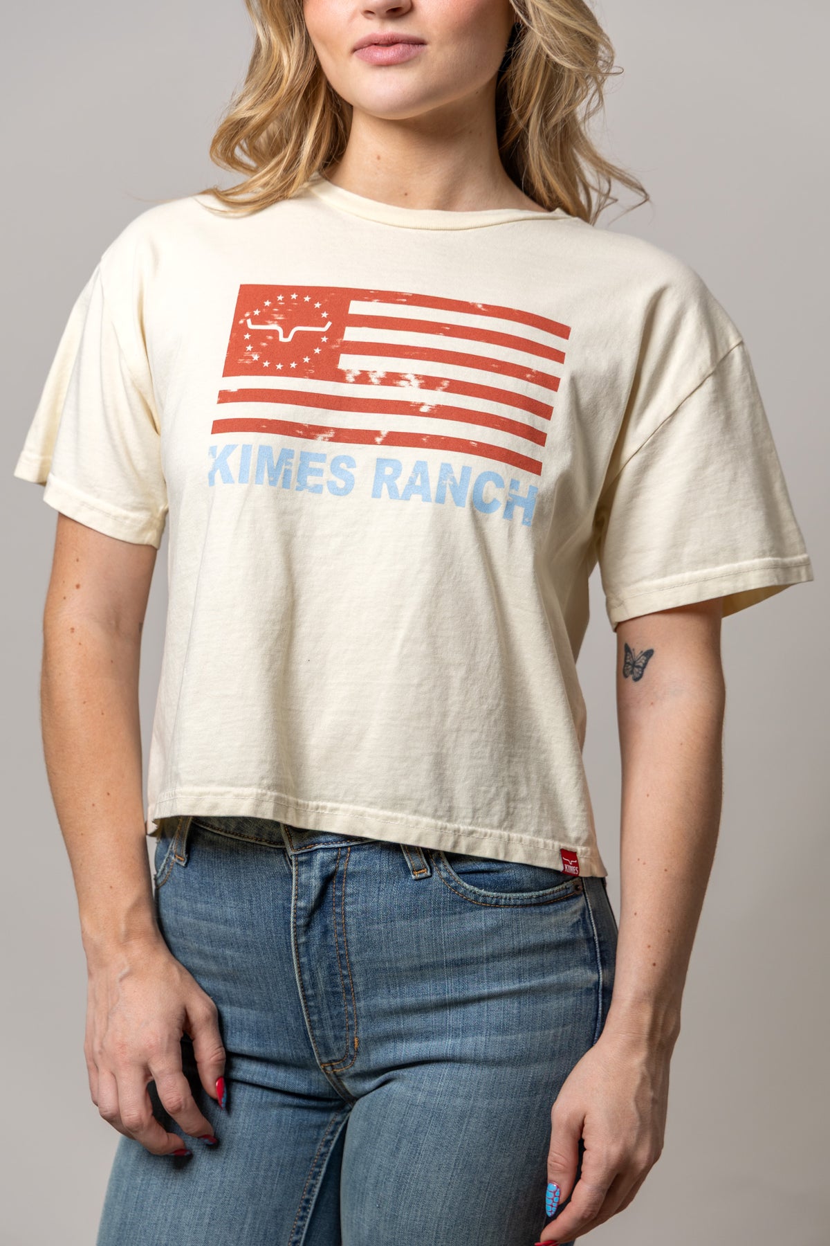 Kimes Ranch 76 shirt in Ivory with a distressed red flag graphic and blue Kimes Ranch text