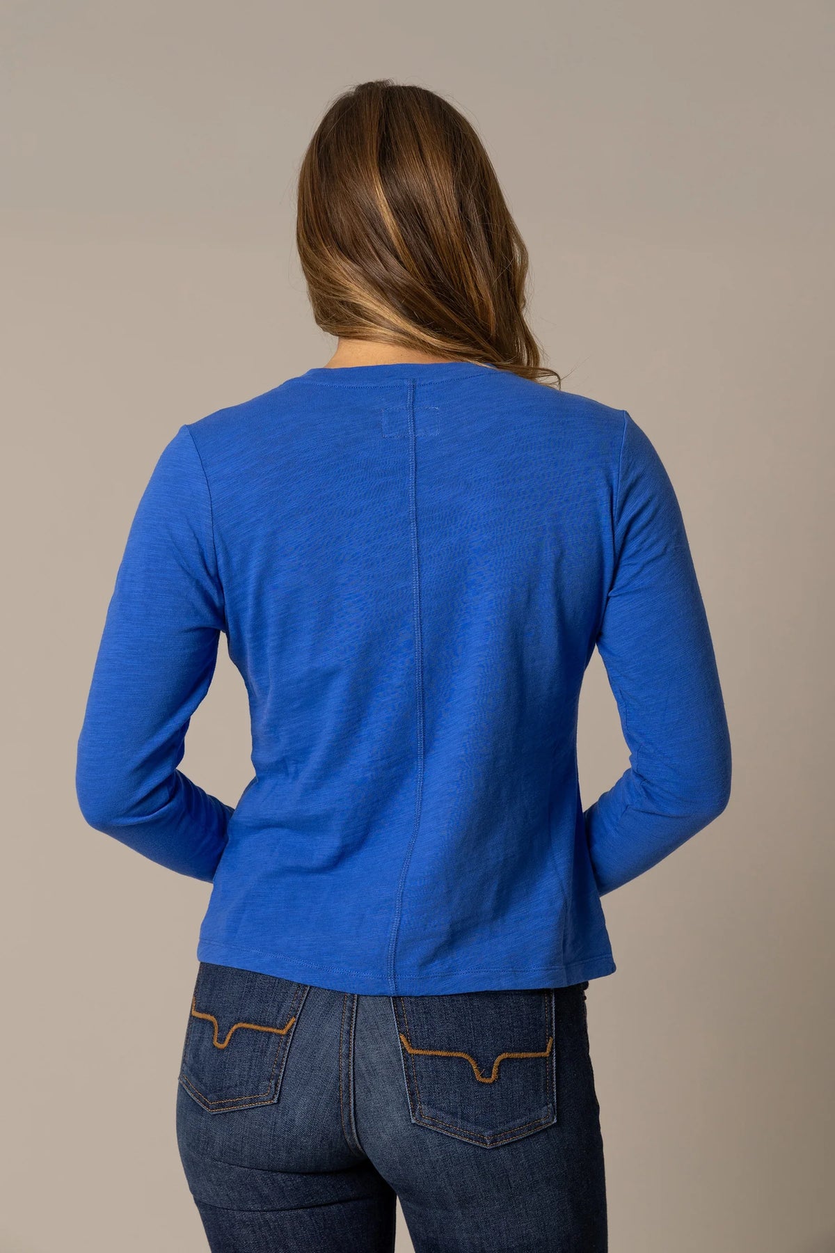 Kimes Ranch Ainsley top in Blue, back view, with long sleeves and a center back seam