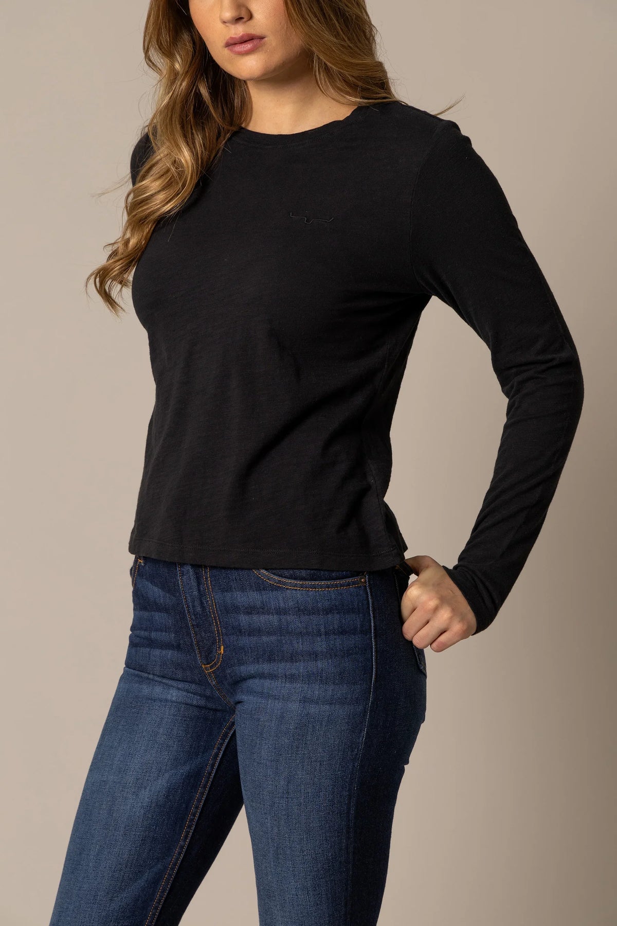 Kimes Ranch Ainsley long sleeve top in Black, side view, with a crew neck and embroidered logo on the chest