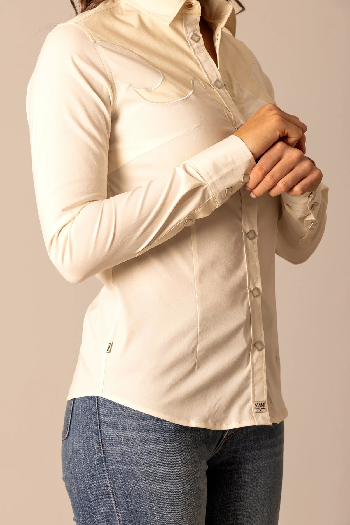 Kimes Ranch Alice top in Natural, side view, with long sleeves, snap front, and contrast stitching