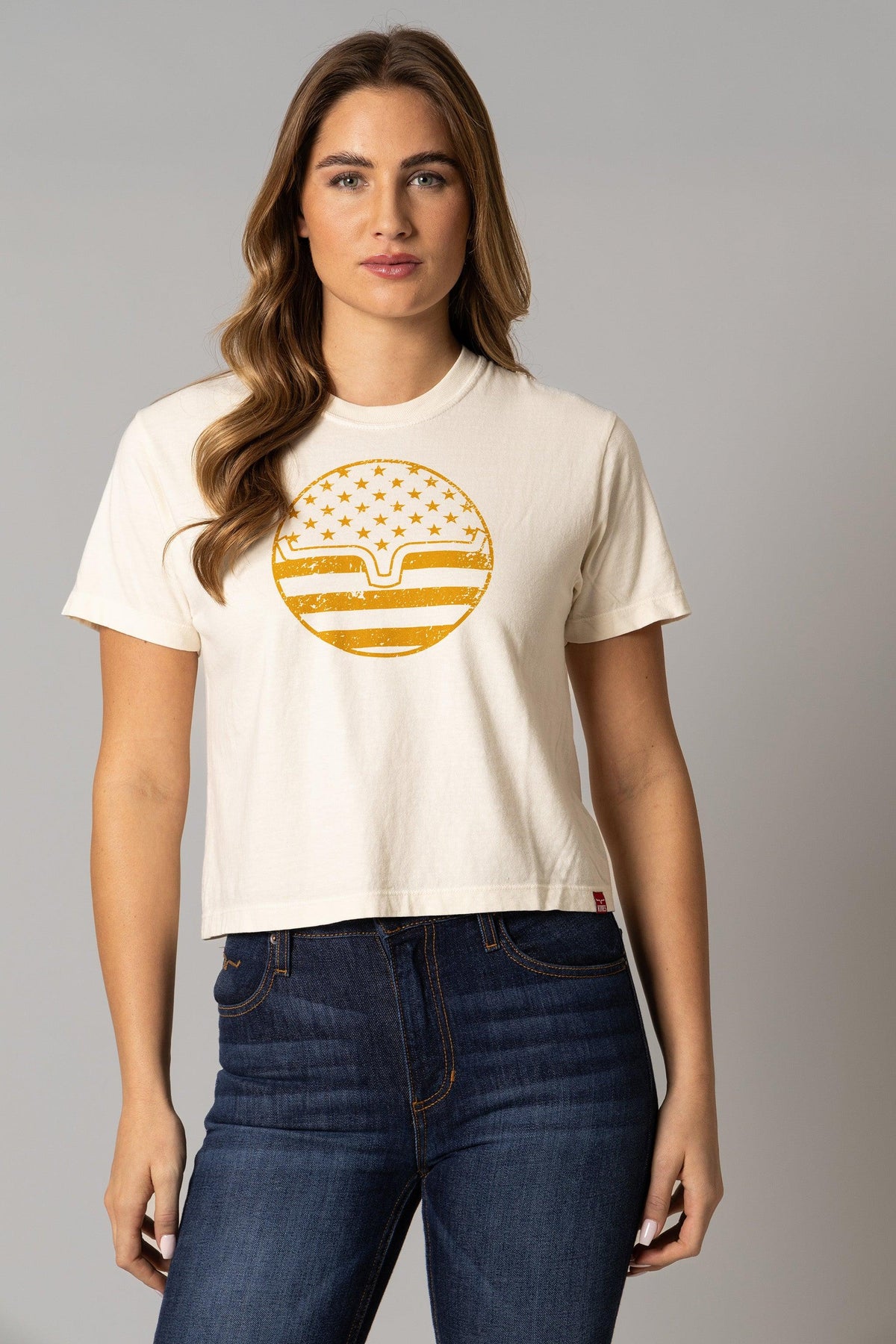 Kimes Ranch Ladies American Bullseye Crop shirt in Ivory with a distressed gold bullseye graphic featuring stars and stripes