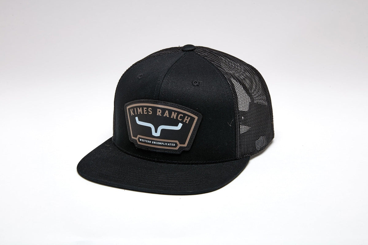 Kimes Ranch Amboy Black trucker hat with a flat brim and the Kimes Ranch logo patch on the front