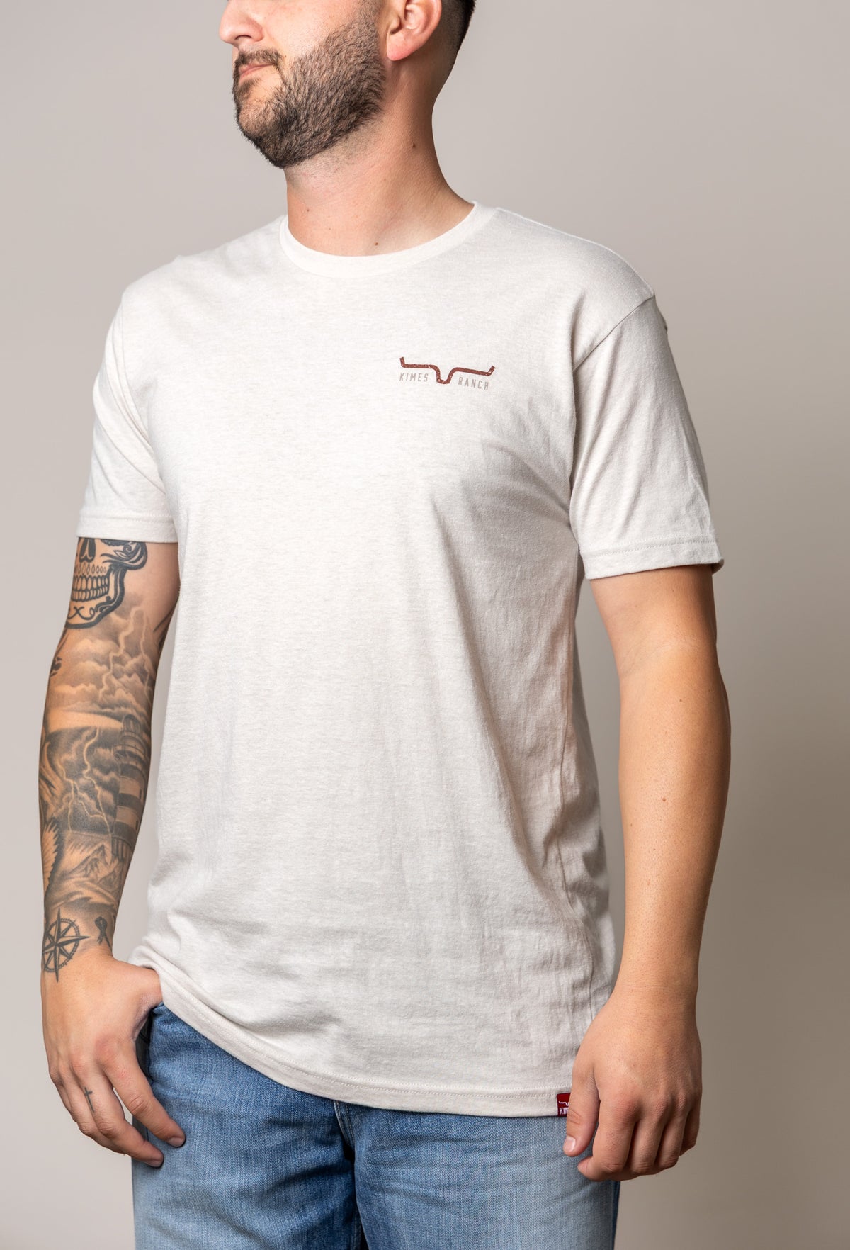 Kimes Ranch American Cowboy shirt in Sand, side view, with crew neck, short sleeves and small Kimes Ranch logo on chest
