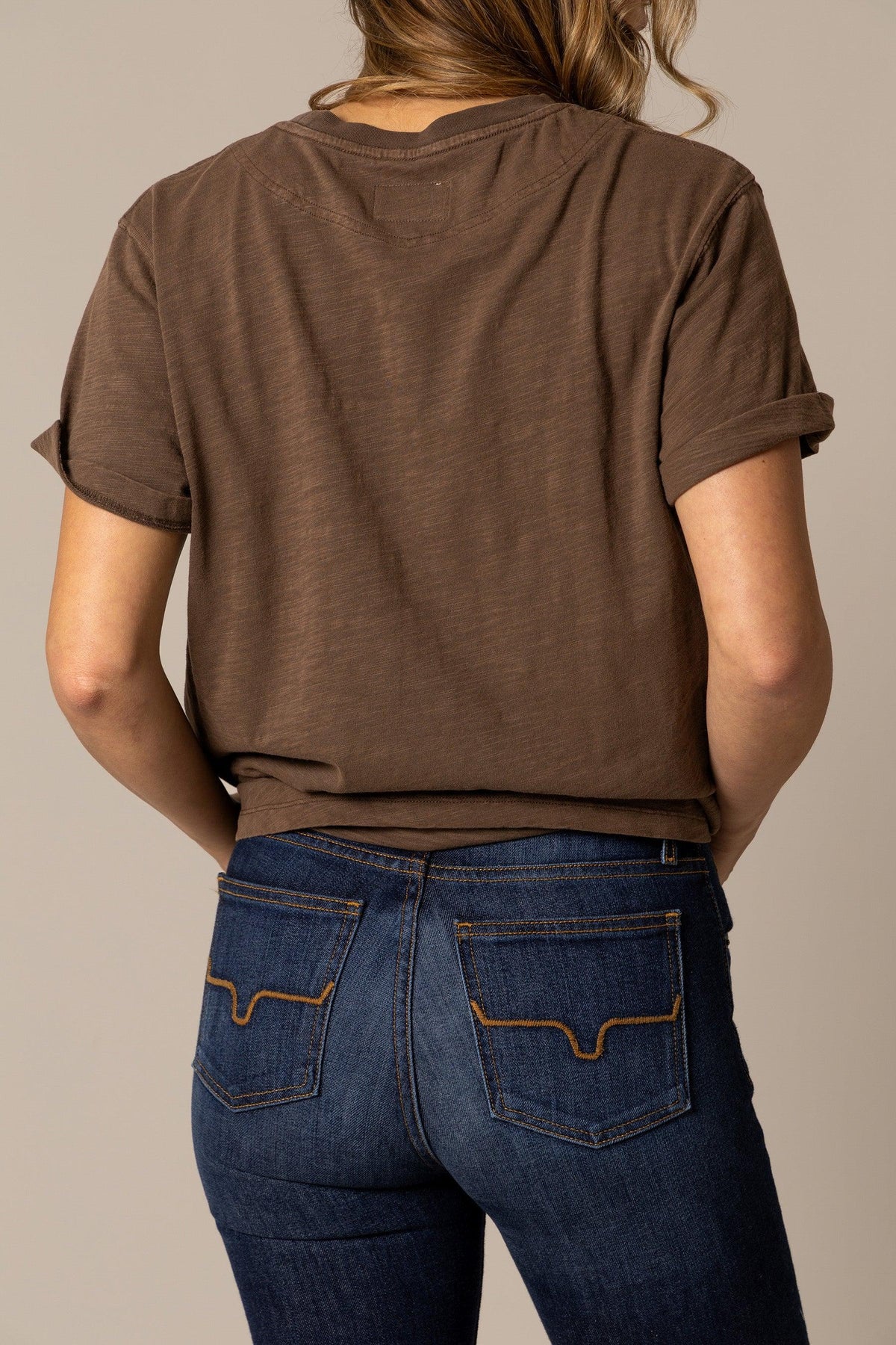 Kimes Ranch Ashley Tee in Cocoa, back view, with rolled short sleeves and a back yoke