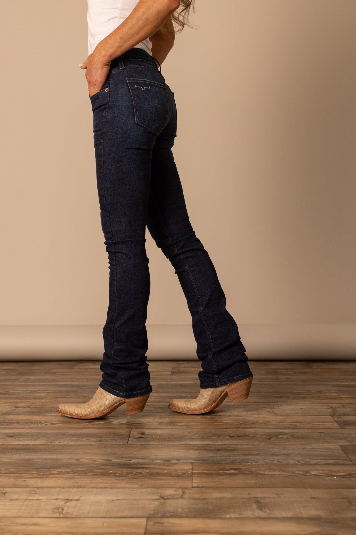 Kimes Ranch Audrey jeans in Dark Wash, side view, with the back pocket logo and bootcut leg
