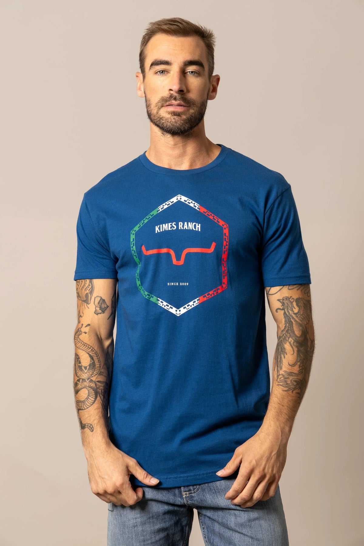 Kimes Ranch Baja Diamond shirt with a hexagonal graphic featuring red horns and a multicolor border