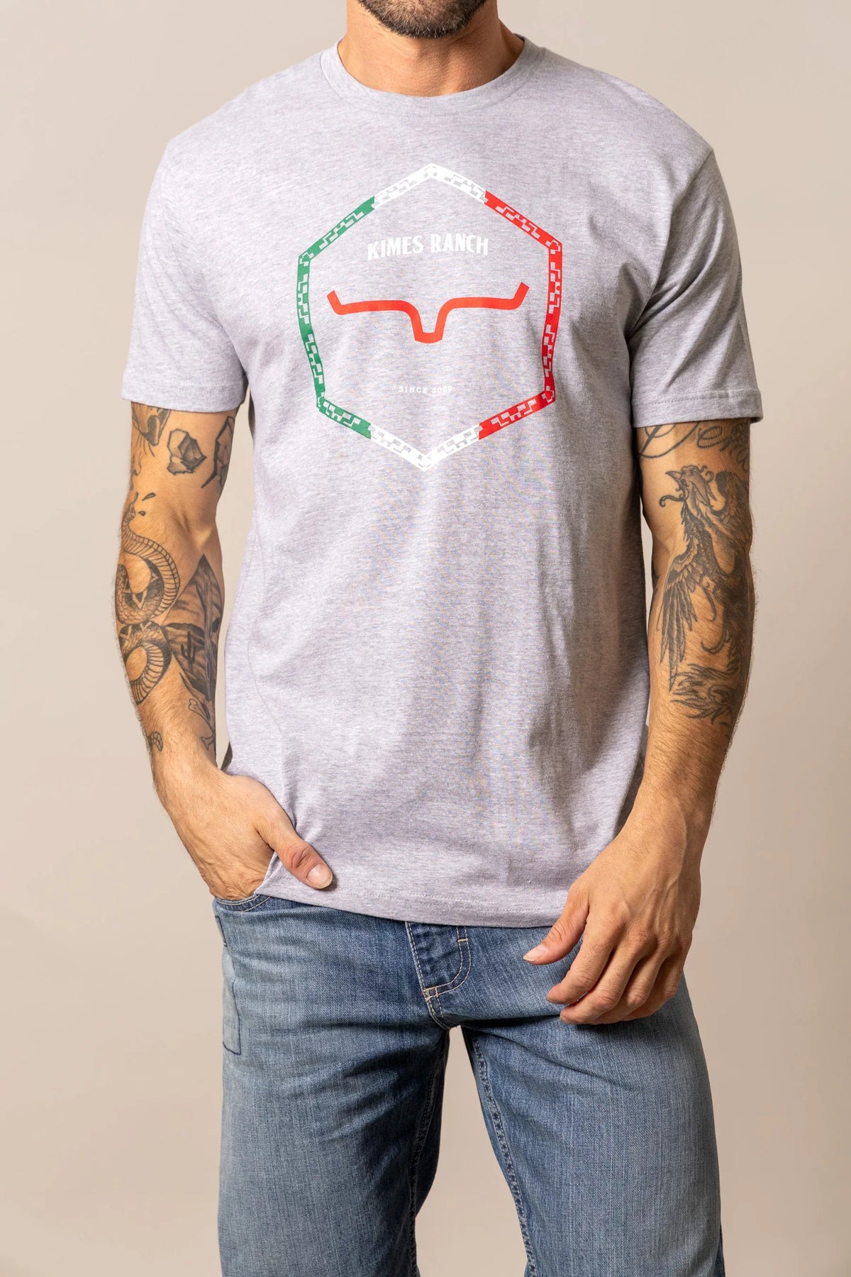 Kimes Ranch Baja Diamond shirt in Heather Grey with a hexagon logo featuring red and green accents