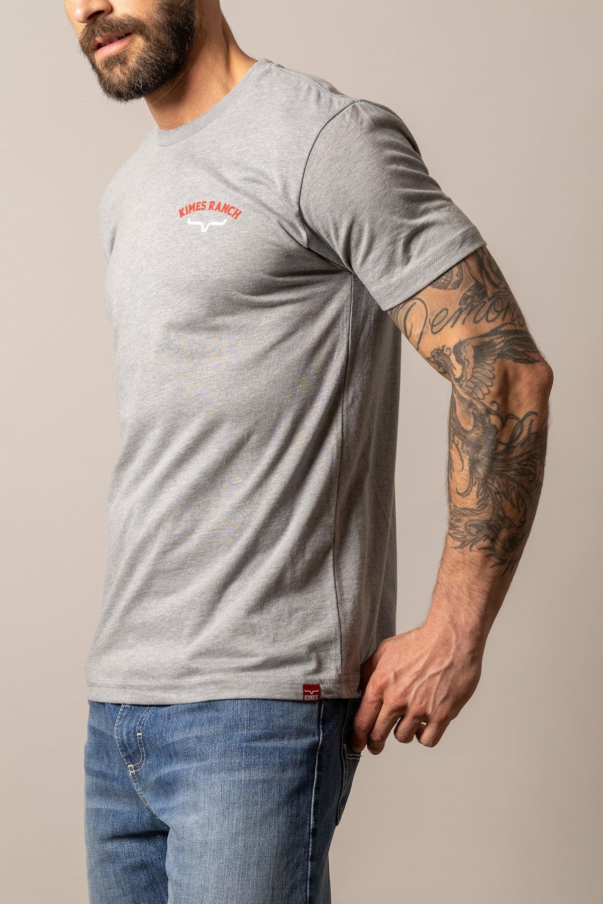 Kimes Ranch Bandera Tee in Dark Grey Heather, side view, with a chest logo and side seam detail