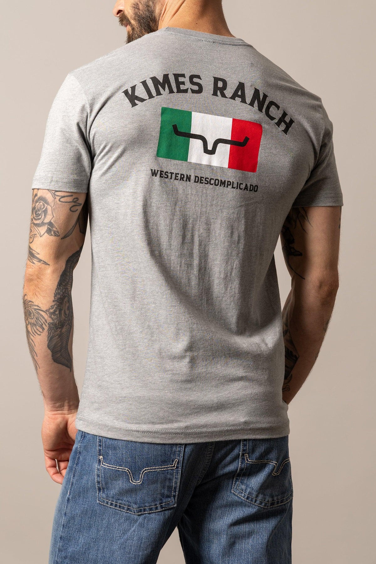 Kimes Ranch Bandera Tee in Dark Grey Heather, back view, with Mexican flag graphic and Kimes Ranch Western Descomplicado text