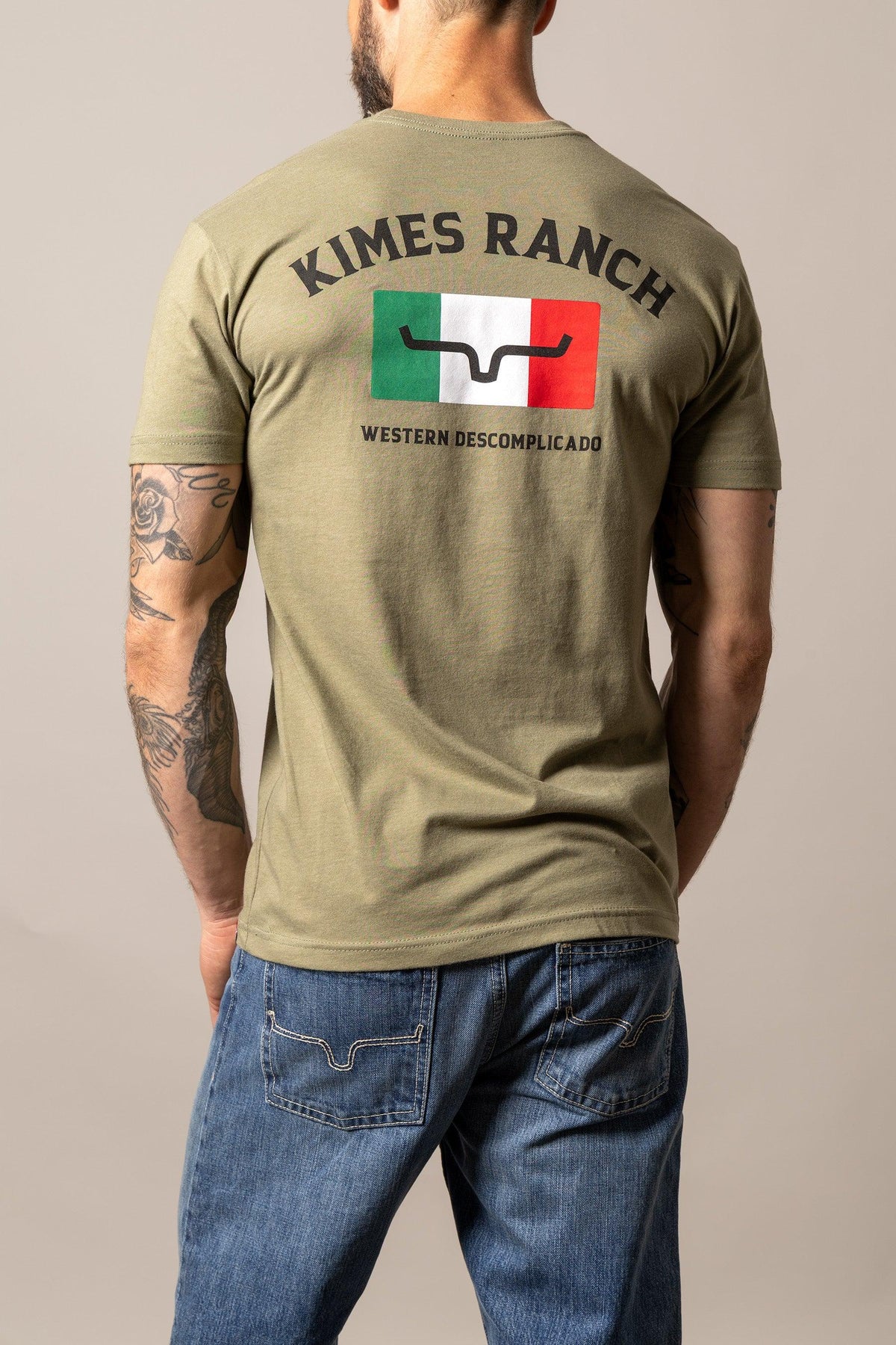 Kimes Ranch Bandera Tee in Light Olive, back view, with back graphic featuring the Kimes Ranch logo