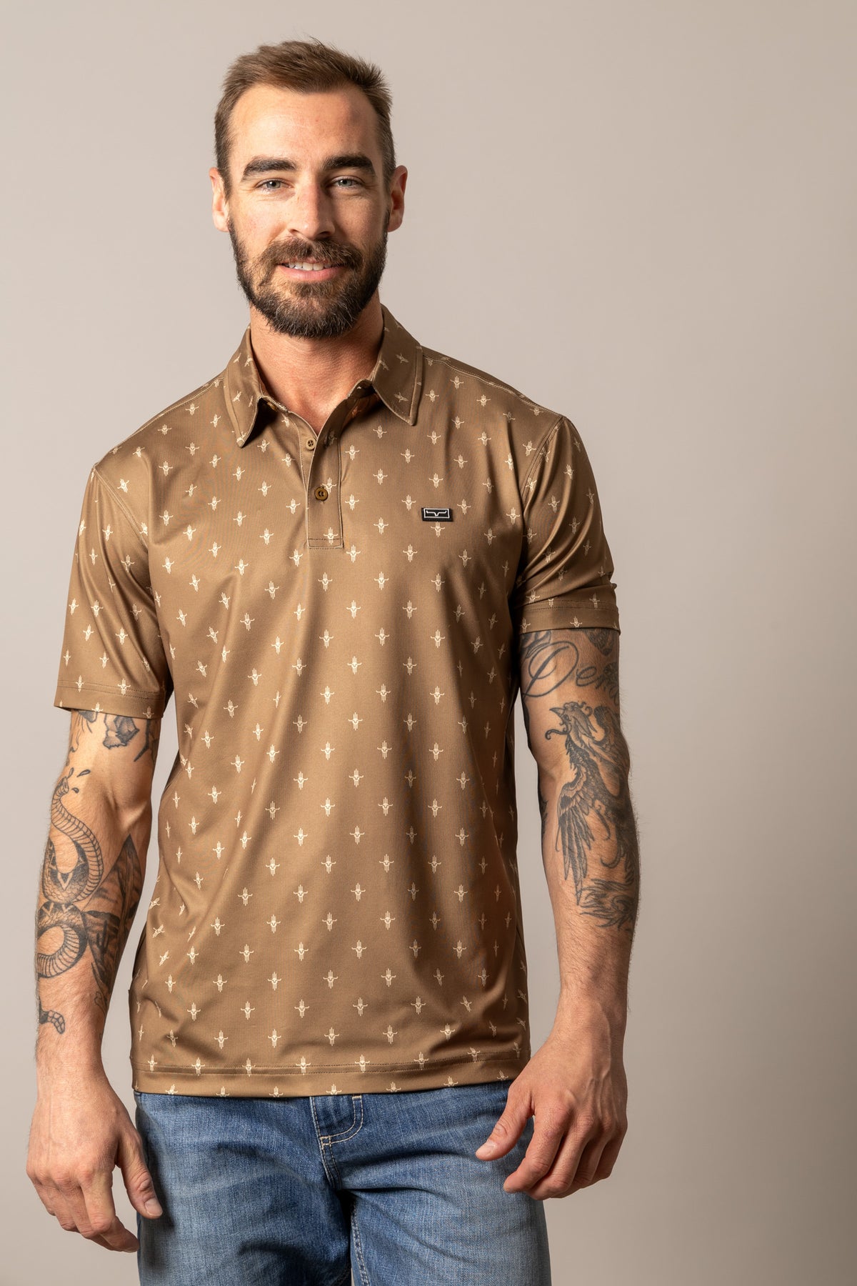Kimes Ranch Bartram polo in Brown with an all-over white Kimes Ranch logo print and a Kimes Ranch logo on the chest
