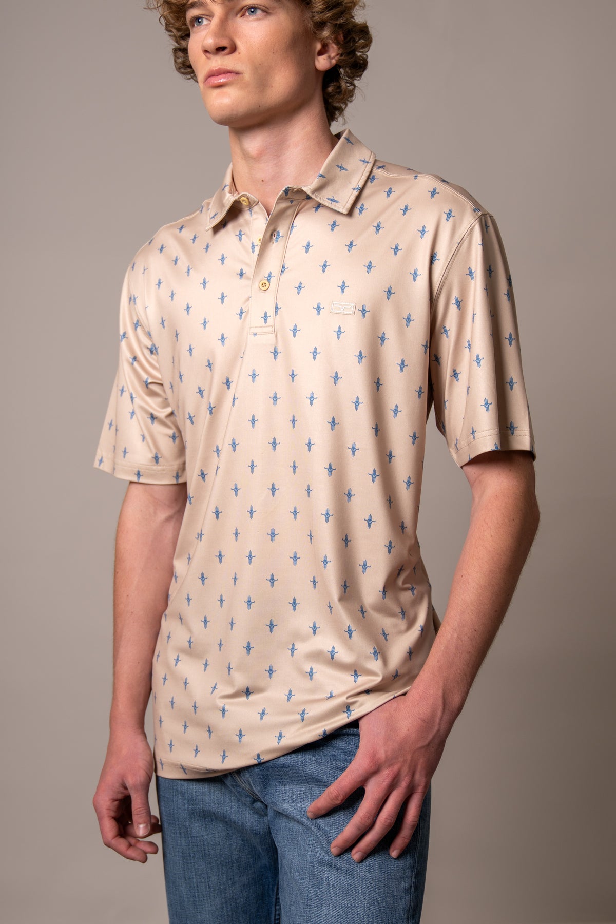 Kimes Ranch Bartram polo in Natural with an all-over blue steer logo print and a chest logo patch
