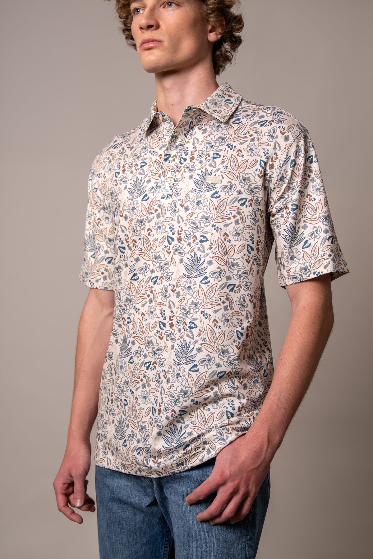 Kimes Ranch Bartram polo in Stone with a blue and brown floral print and a chest logo