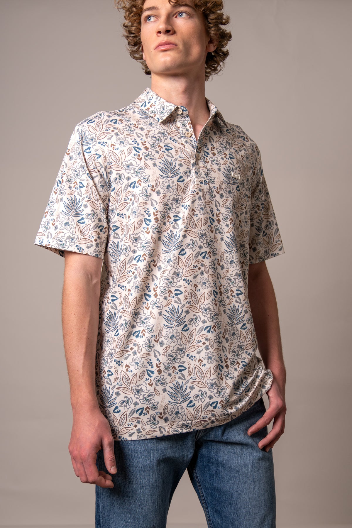 Kimes Ranch Bartram polo in Stone with a blue and brown botanical print and a chest logo