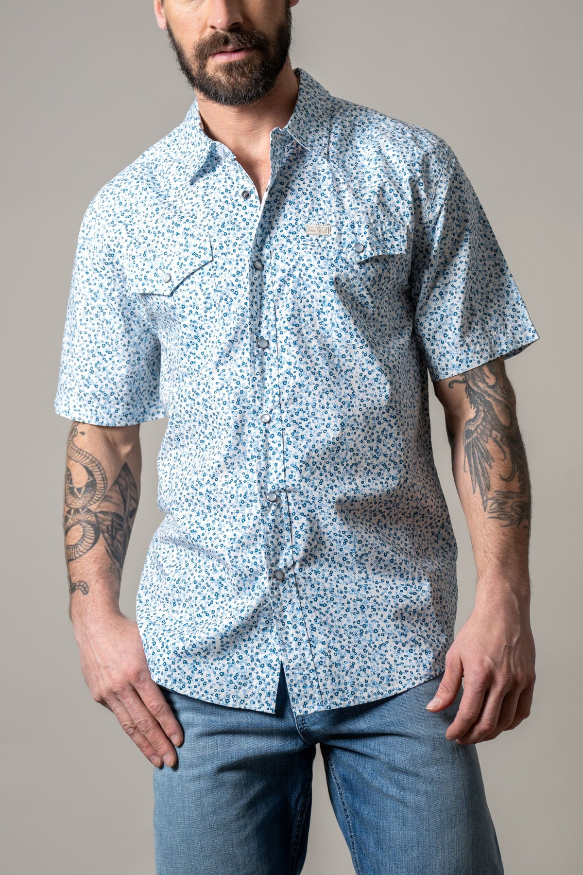 Kimes Ranch Bascom short sleeve dress shirt in blue with a small floral print and two chest pockets with button flaps