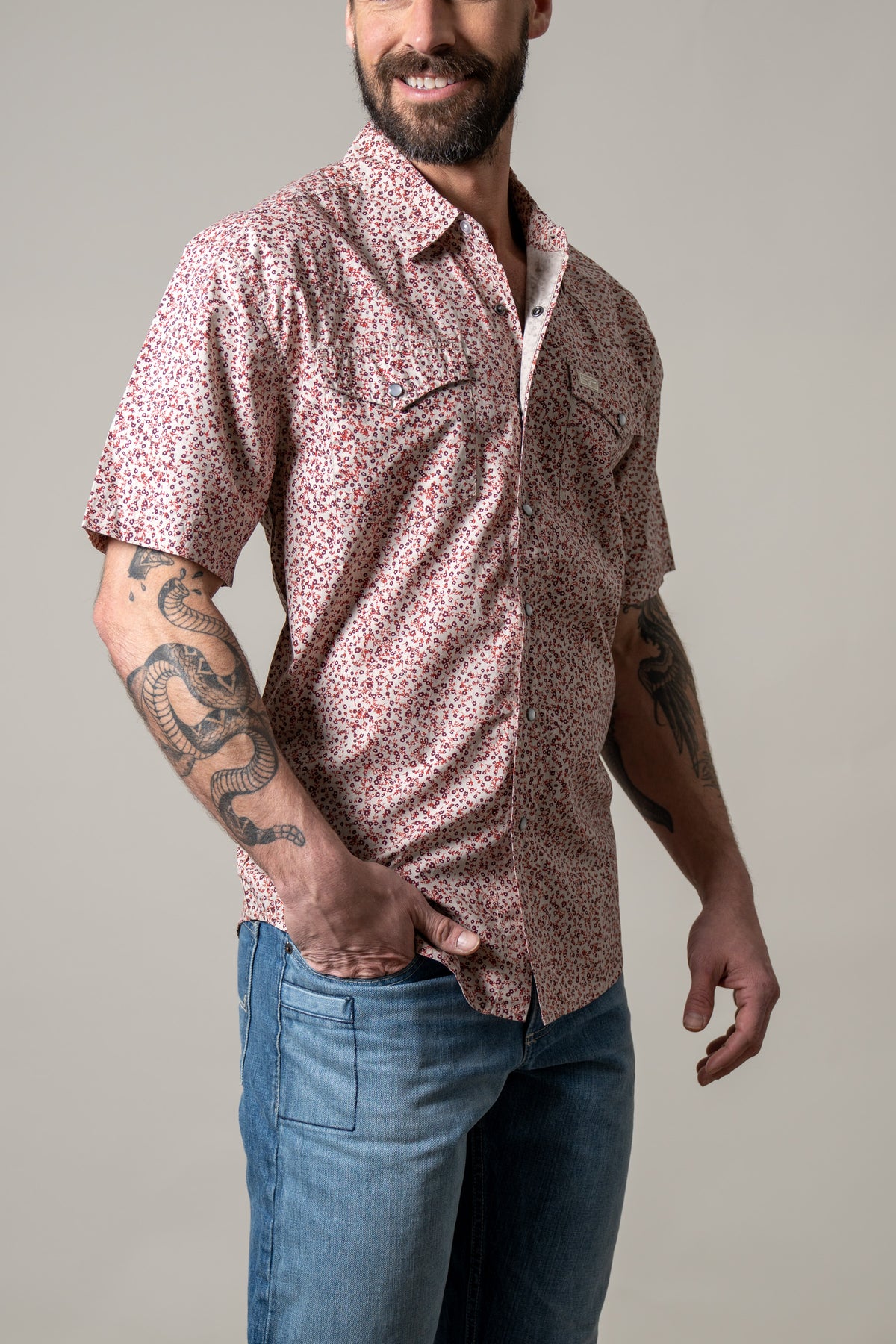 Kimes Ranch Bascom short sleeve dress shirt in Red, side view, with a small floral print and two chest pockets