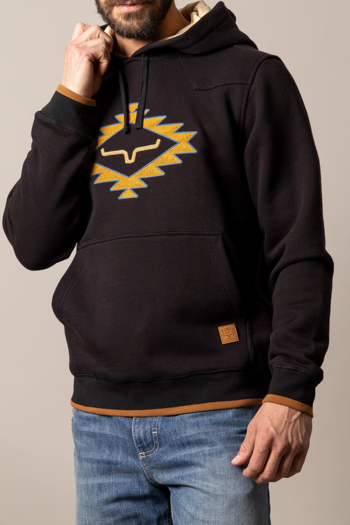 Kimes Ranch Berger hoodie in Black with a mustard and blue geometric Kimes Ranch logo and a kangaroo pocket