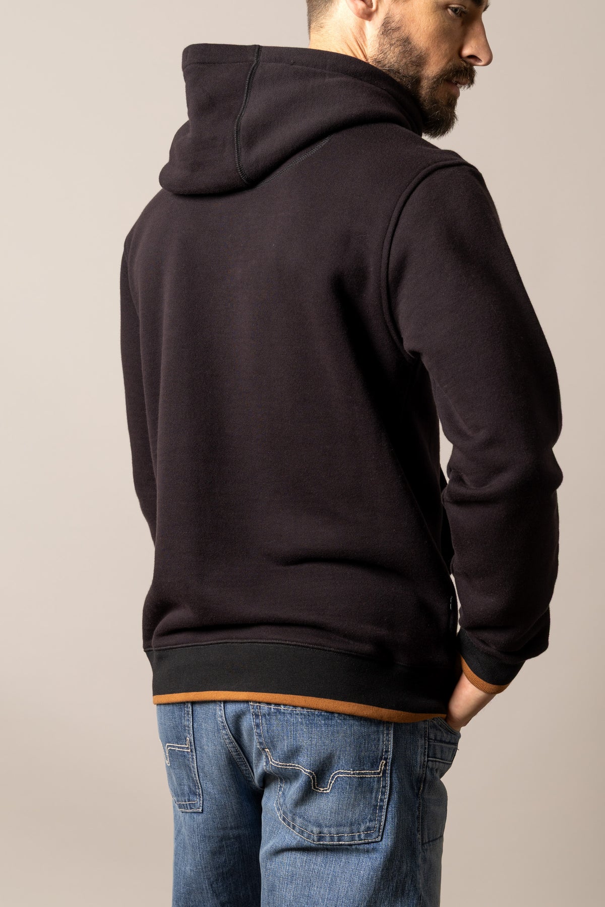 Kimes Ranch Berger hoodie in Black, back view, with contrast stitching and a tan hem detail