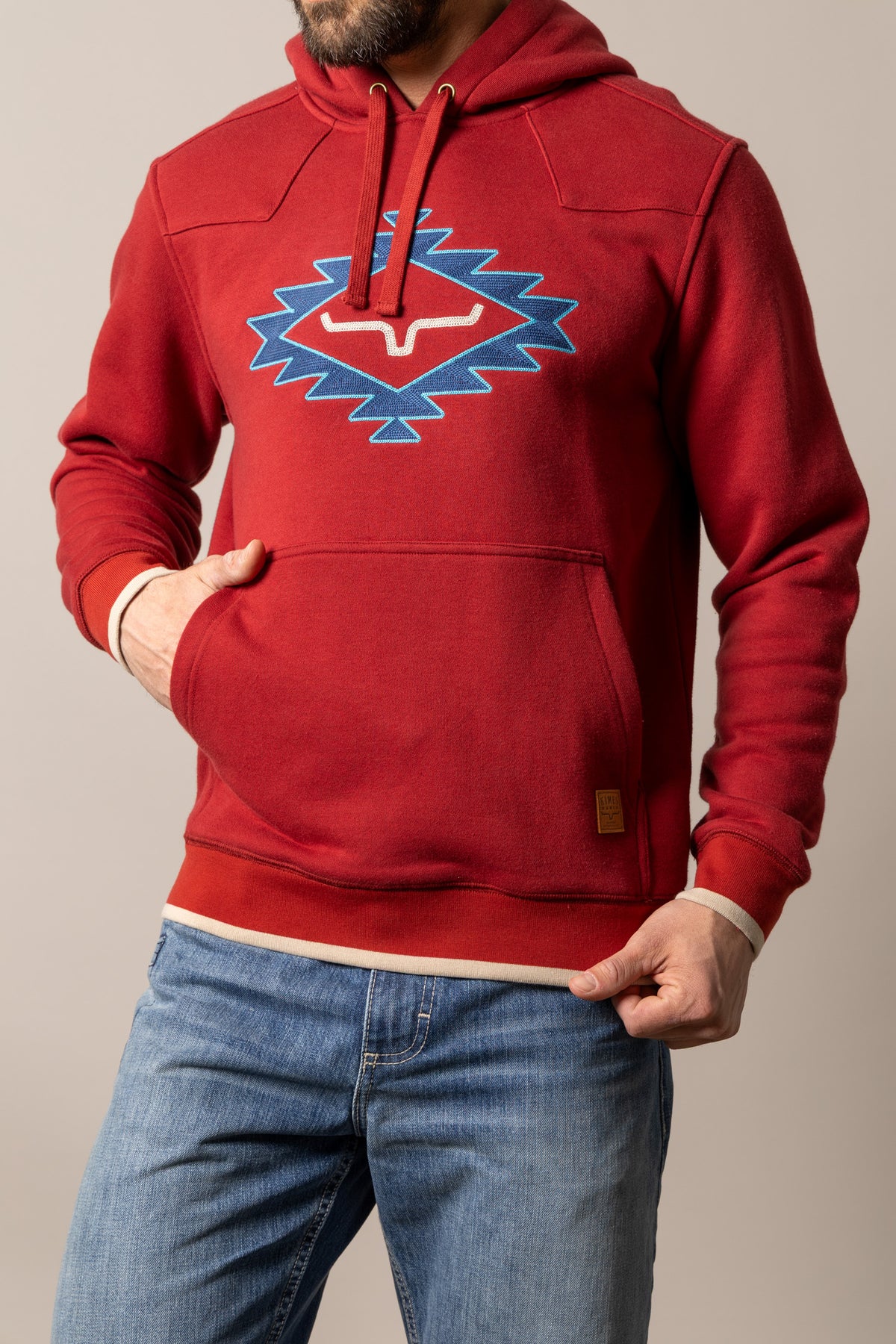 Kimes Ranch Berger hoodie in Brick Red with a blue and white embroidered Kimes Ranch logo and a front kangaroo pocket