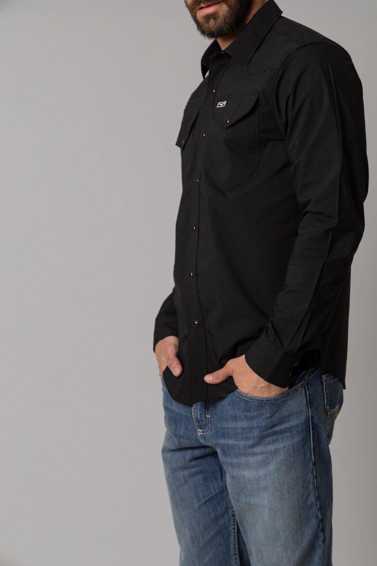 Kimes Ranch Blackout Dress Shirt in Black, side view, with long sleeves and chest pockets