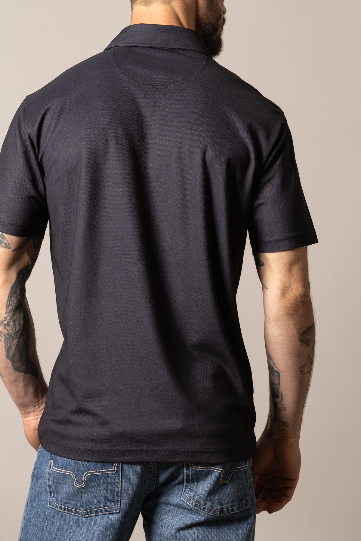 Kimes Ranch Bowman polo shirt in Black, back view, with a back yoke and short sleeves