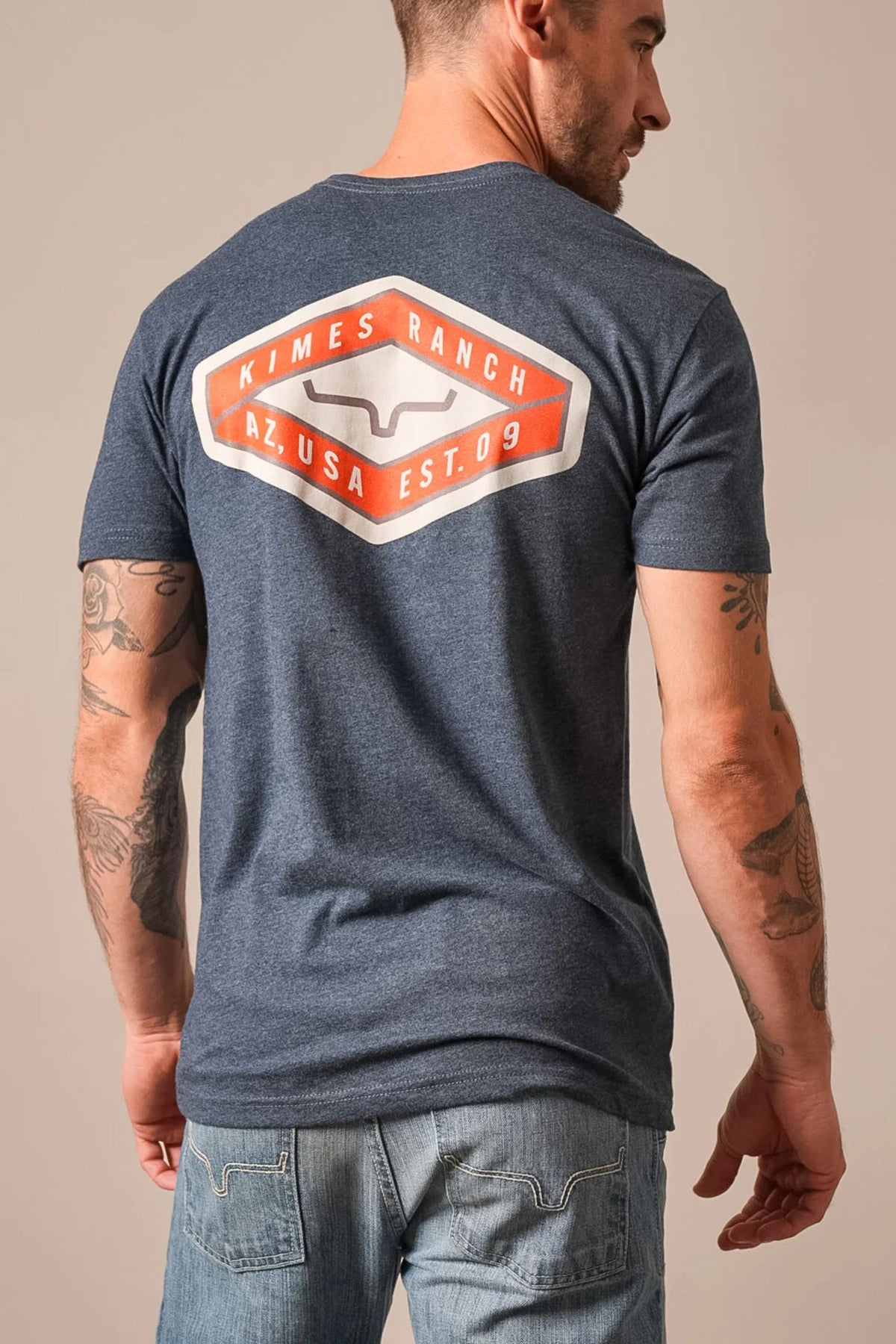 Kimes Ranch Boxer shirt in Midnight Navy, back view, with a large back graphic featuring the Kimes Ranch logo