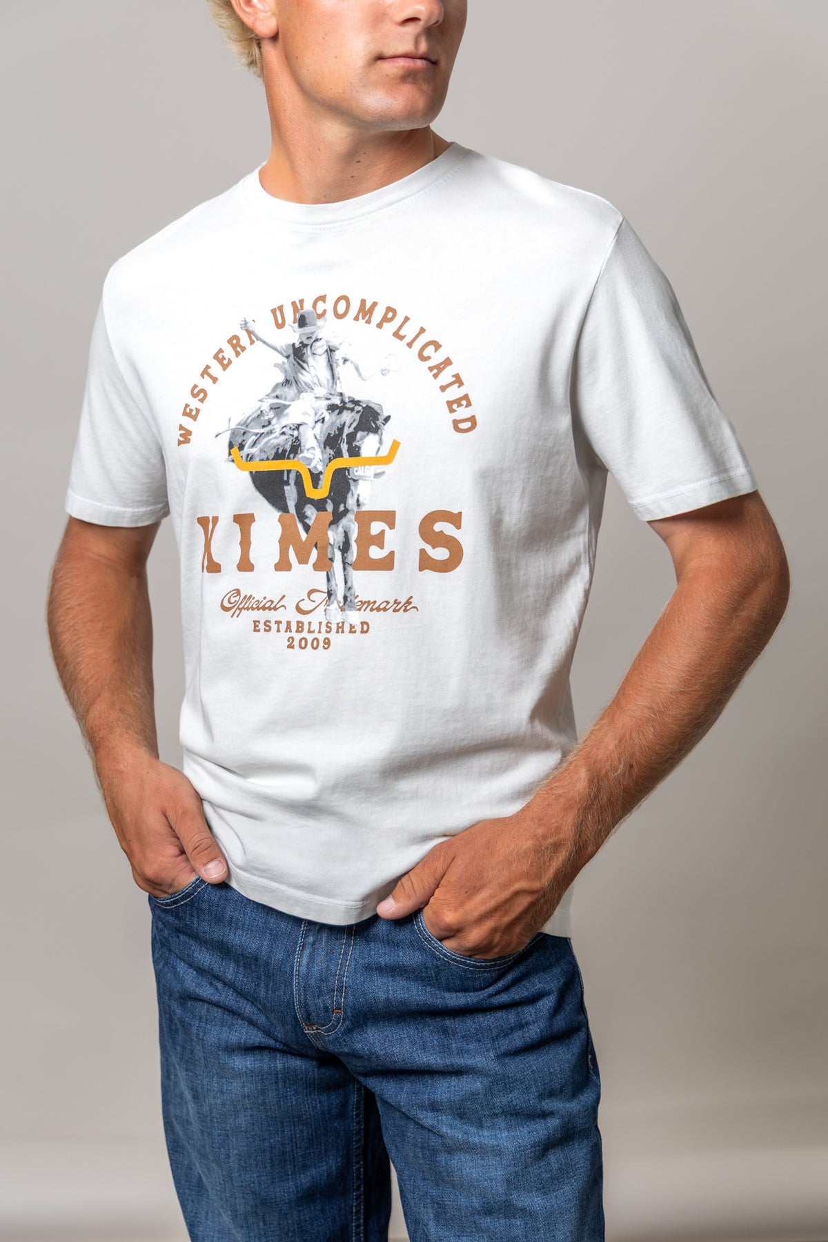 Kimes Ranch Break Through shirt in Natural with a cowboy on a longhorn graphic and Western Uncomplicated text