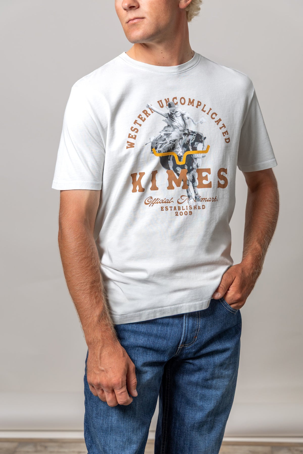 Kimes Ranch Break Through shirt in Natural with a cowboy riding a longhorn graphic and Western Uncomplicated text