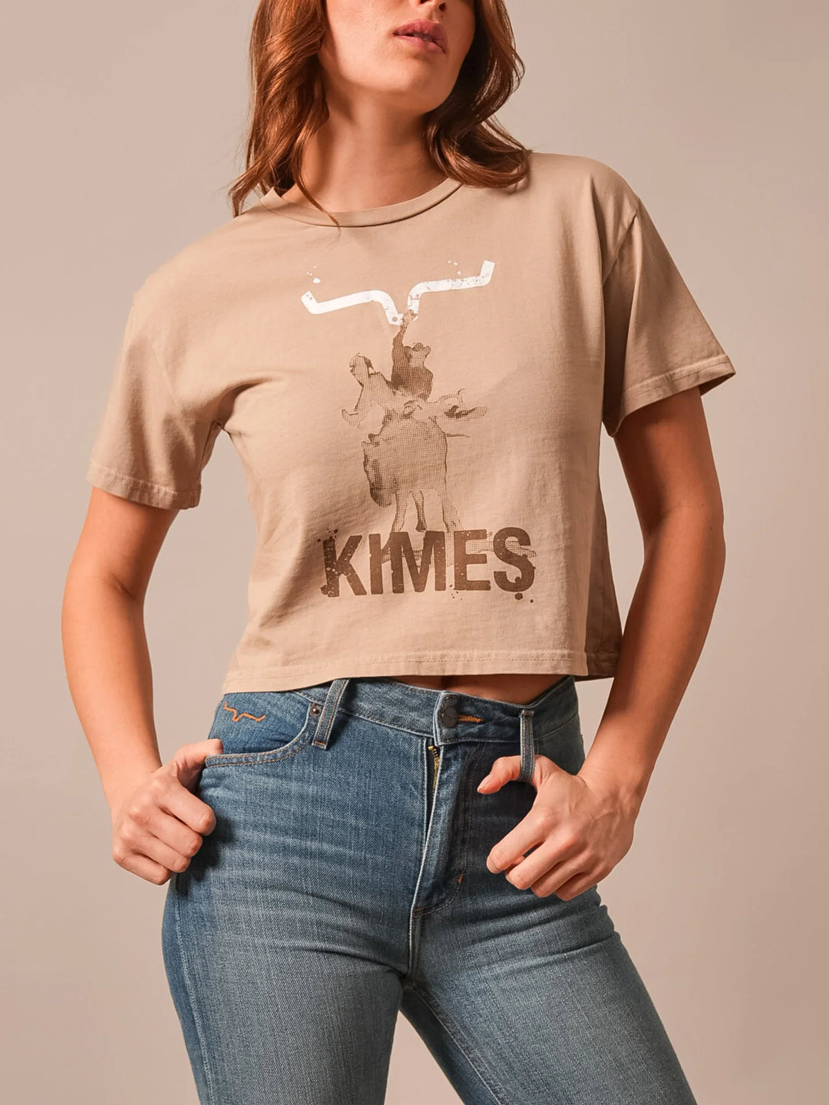 Kimes Ranch Bucks shirt in Tan with a graphic of a cowboy on a bucking horse and the word KIMES