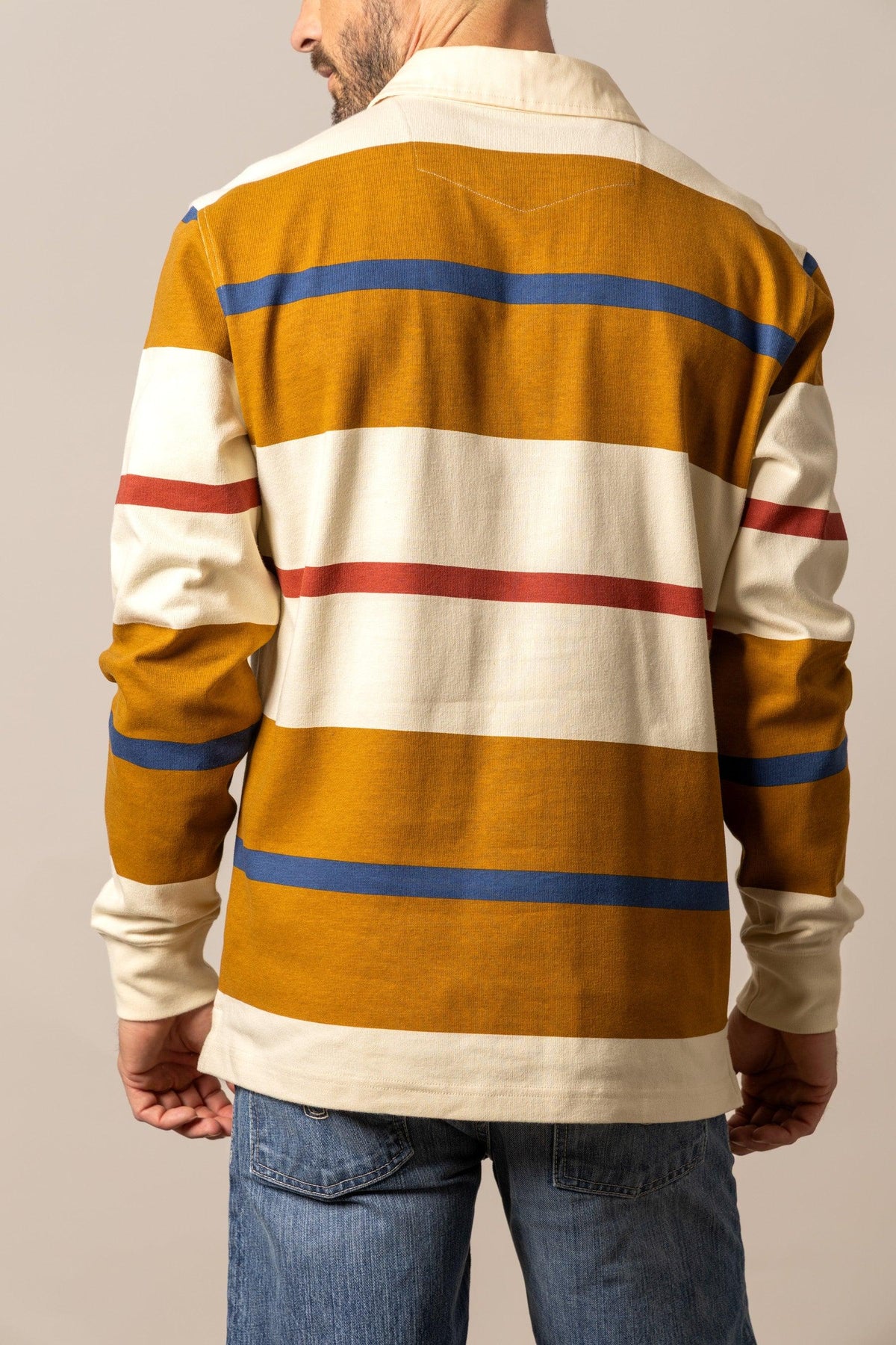 Kimes Ranch Bulldog Rugby polo in Work Wear Brown, back view, with wide horizontal stripes in cream, blue, and red