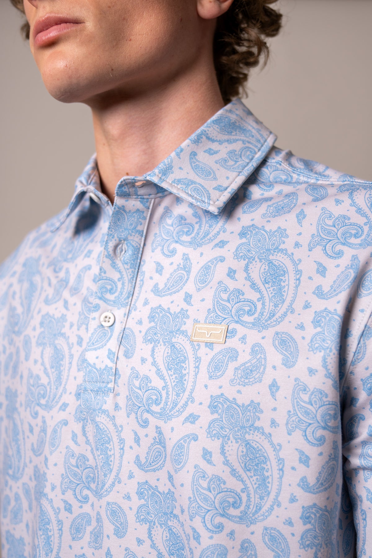 Kimes Ranch Burel polo in Blue with a paisley print and a close-up of the collar and logo