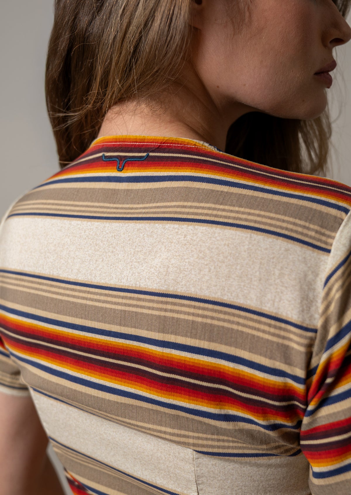 Kimes Ranch Celeste dress in Natural, back view, with multicolor horizontal stripes and a Kimes Ranch logo at the back yoke