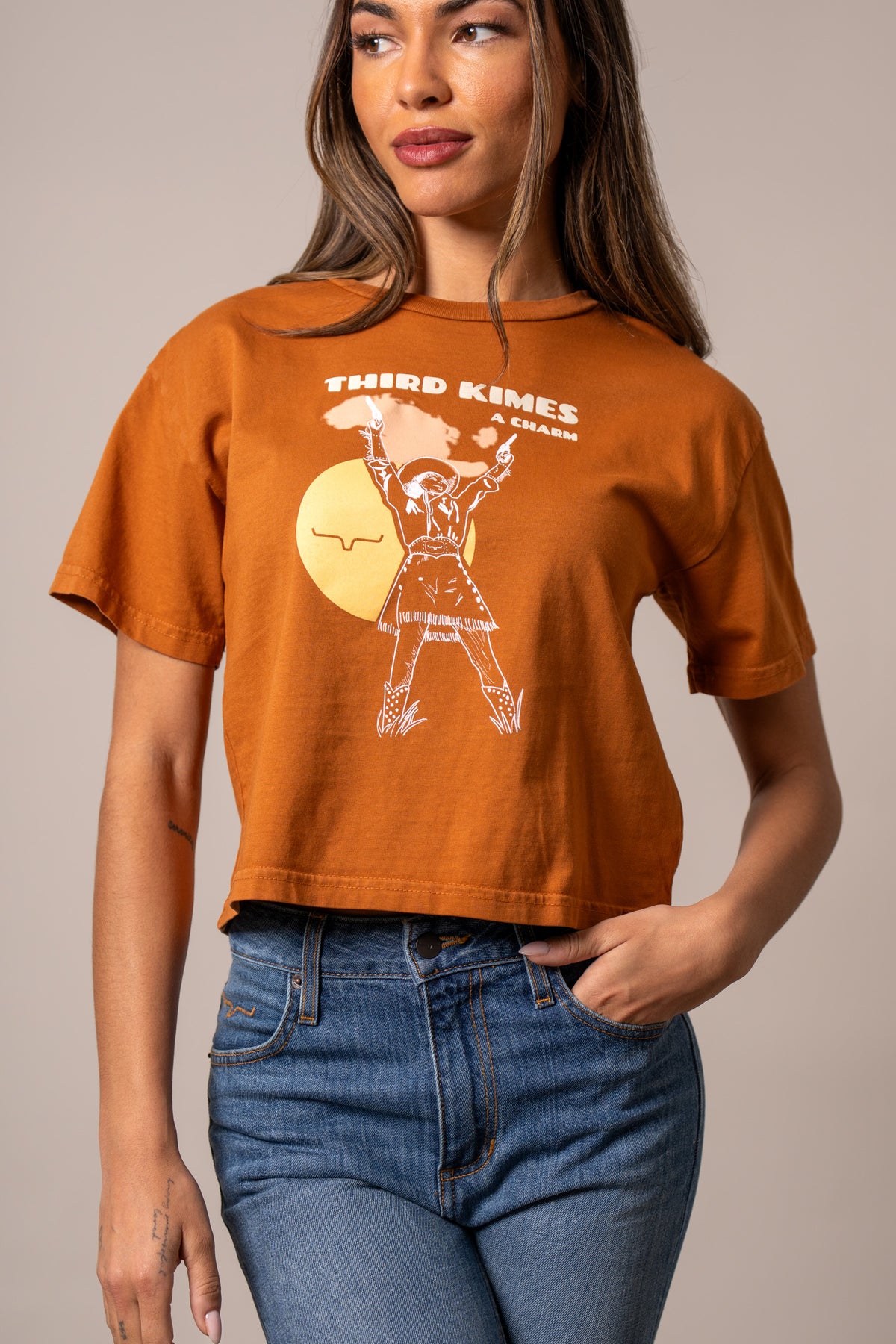 Kimes Ranch Charming shirt in Rust with a graphic of a woman in a cowboy hat with THIRD KIMES A CHARM text