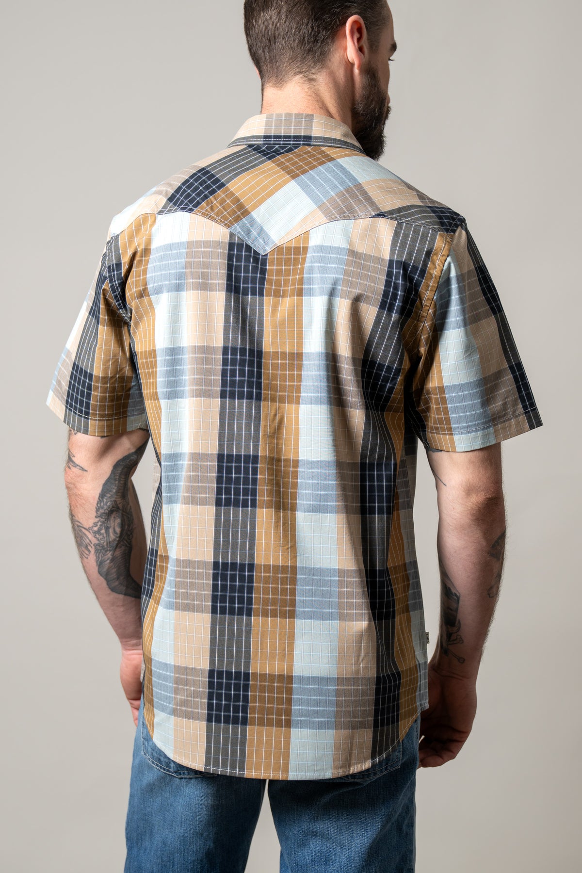 Kimes Ranch Chico dress shirt in Brown, back view, with a plaid pattern and short sleeves