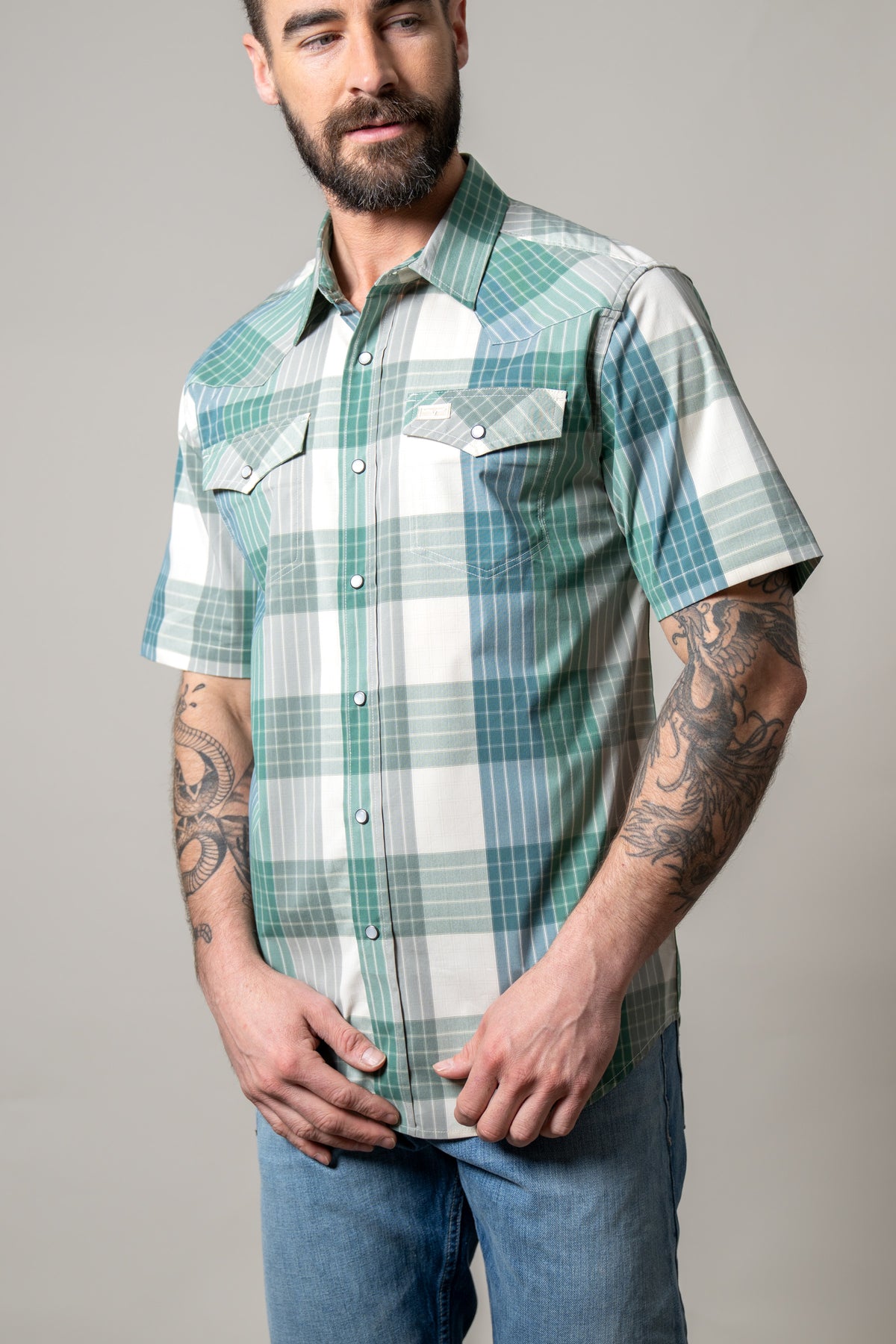 Kimes Ranch Chico short sleeve dress shirt in Green with a plaid pattern and two buttoned chest pockets