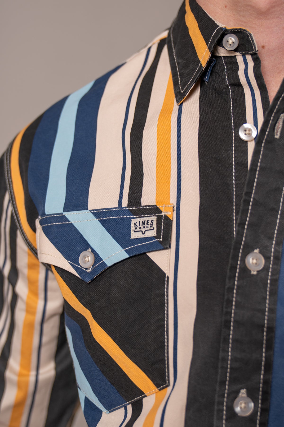Kimes Ranch Clancy dress shirt in Black, close-up, with multi-color stripes and a chest pocket with logo