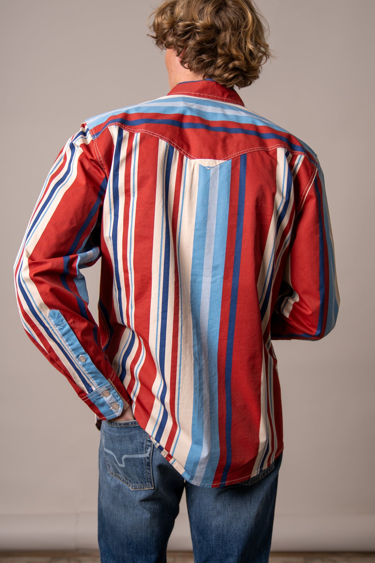 Kimes Ranch Clancy dress shirt in Brick Red, back view, with vertical stripes in blue and white and a back yoke