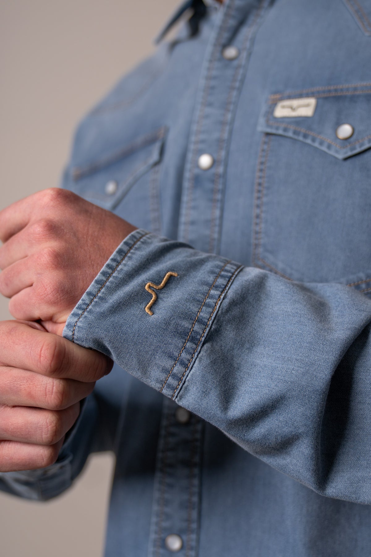 Kimes Ranch Cleavon dress shirt in Blue with a close-up of the embroidered logo on the cuff
