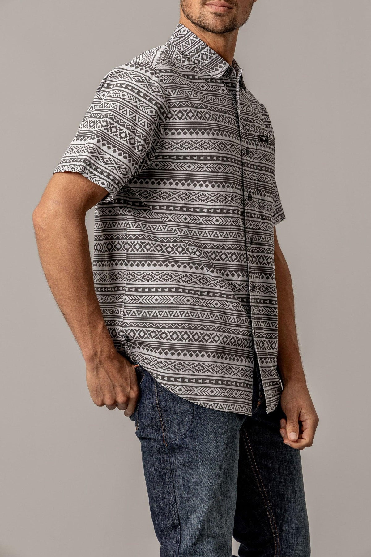 Kimes Ranch Colton short sleeve dress shirt in Grey, side view, with a geometric tribal print pattern
