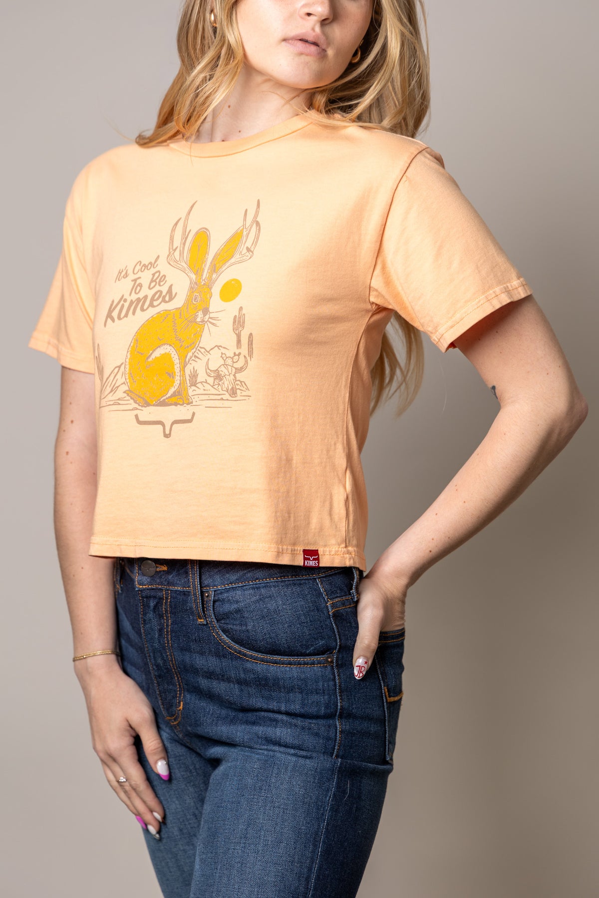 Kimes Ranch Cool Jack short sleeve shirt in Peach with a jackrabbit graphic and text reading It's Cool To Be Kimes