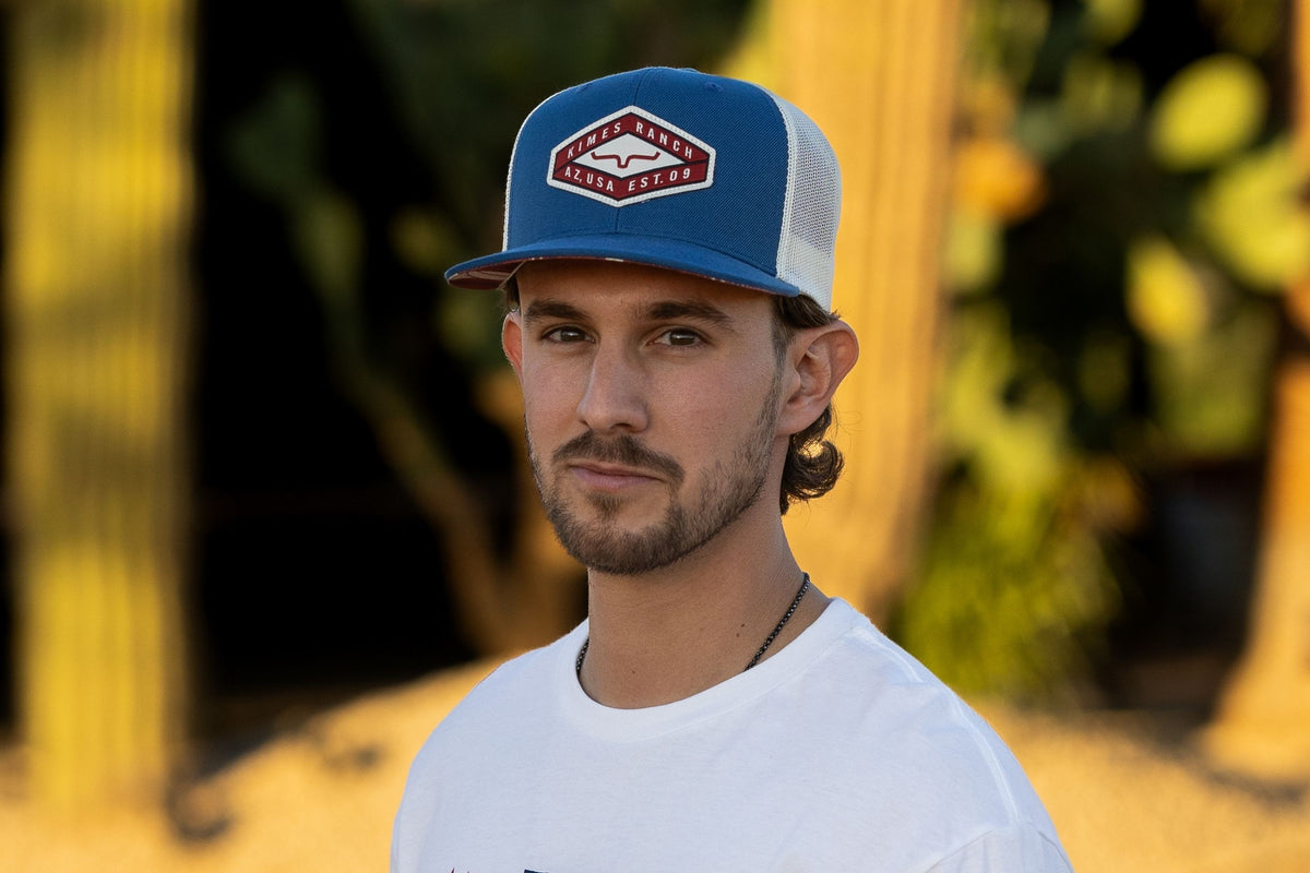 Kimes Ranch Boxer Trucker hat in Blue with the Kimes Ranch logo on the front