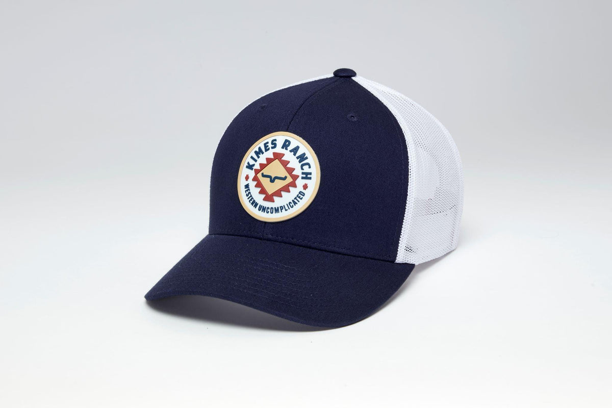 Kimes Ranch Vaughn hat in Navy, side view, with white mesh back and a circular logo patch with Western Uncomplicated text