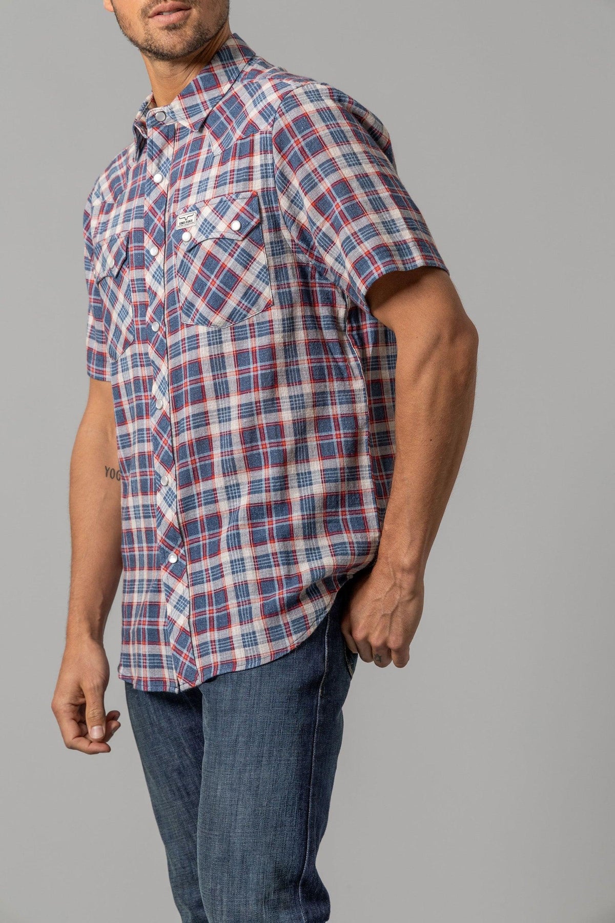Kimes Ranch Danford short sleeve plaid dress shirt in Blue, side view, with chest pockets and a logo patch