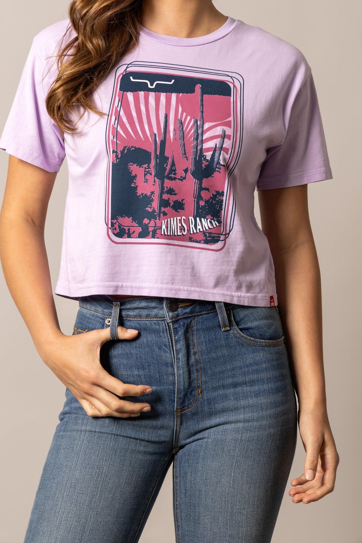 Kimes Ranch Desert Trip shirt in Orchid with a graphic of cacti and a sunset with Kimes Ranch text