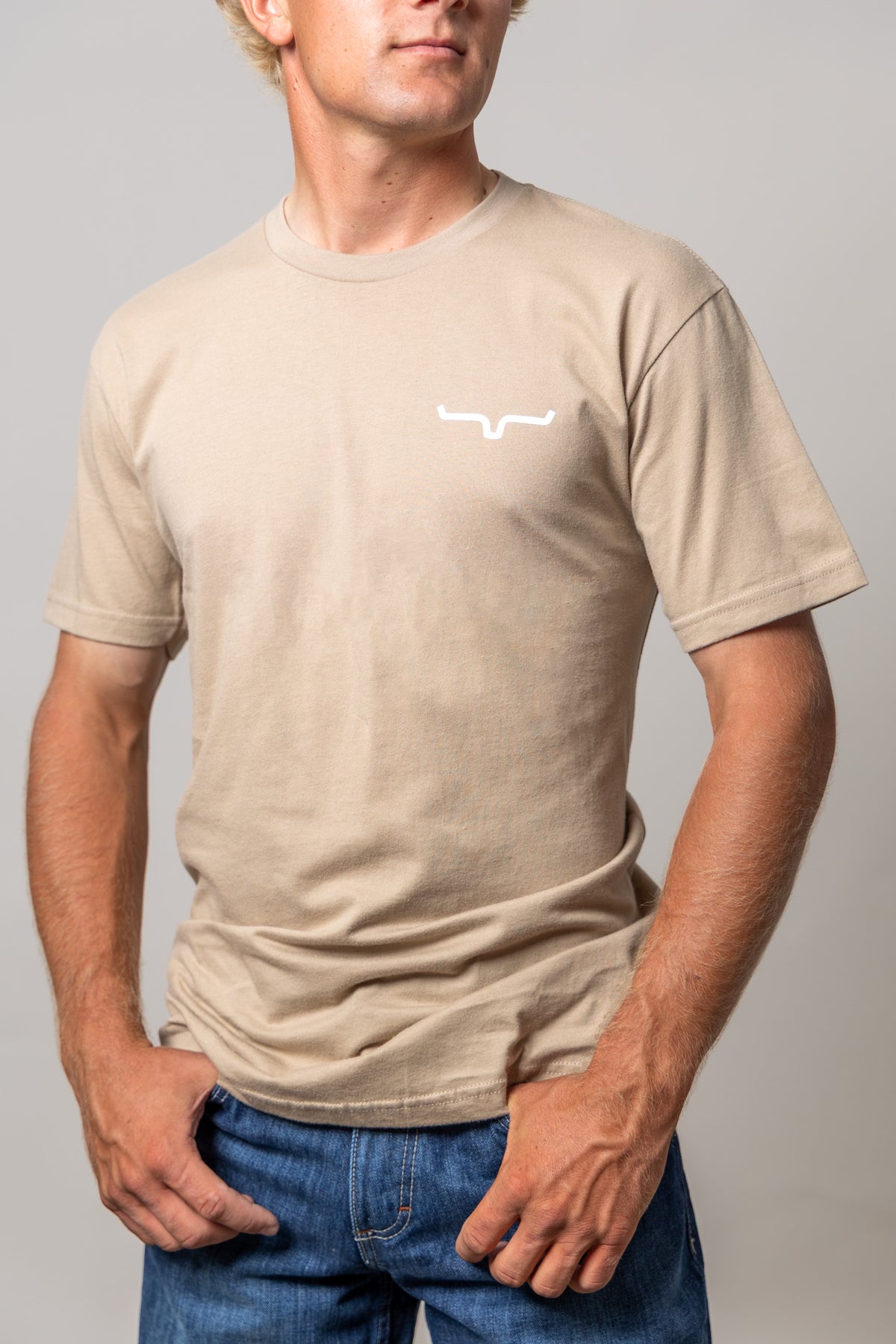 Kimes Ranch Dillard Floral shirt in Tan with short sleeves and a white Kimes Ranch logo on the chest