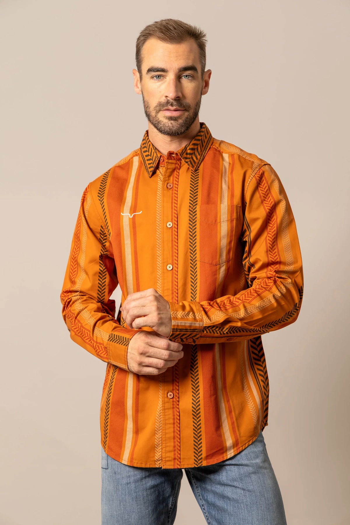 Kimes Ranch Double Tap long sleeve dress shirt in Burnt Orange with vertical stripes and a white logo on the chest